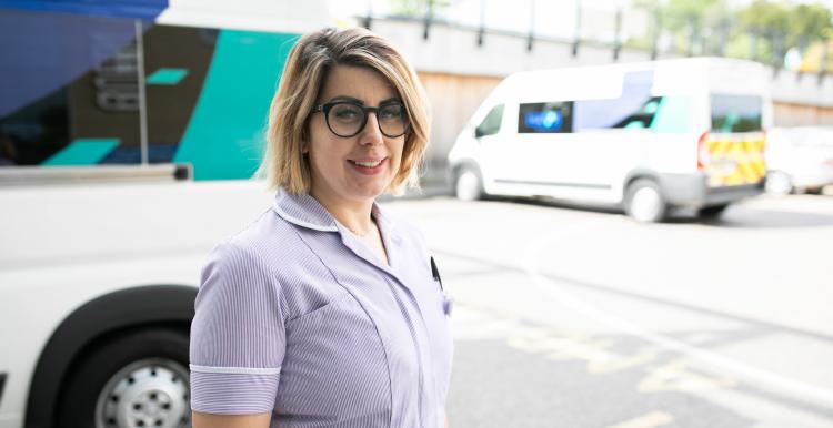 A nurse standing outside a hospital